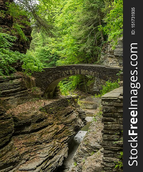 The Stone Bridge leads hikers toward Lucifer Falls at Robert H Treman State Park. The Stone Bridge leads hikers toward Lucifer Falls at Robert H Treman State Park.