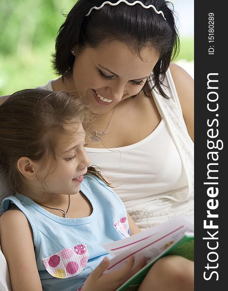 Portrait of happy mother with daughter having good time in summer environment. Portrait of happy mother with daughter having good time in summer environment