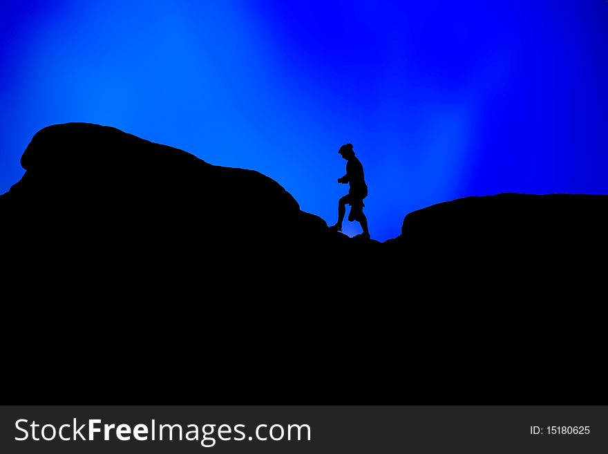 Silhouettes of people on a hill