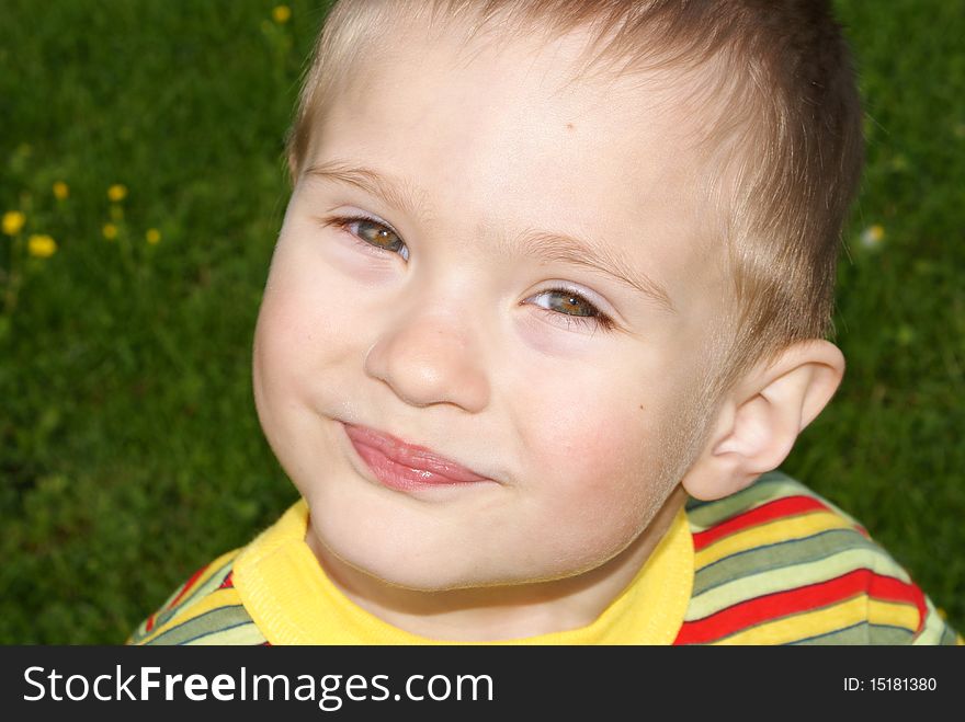 A smiling child looks into the camera, portrait