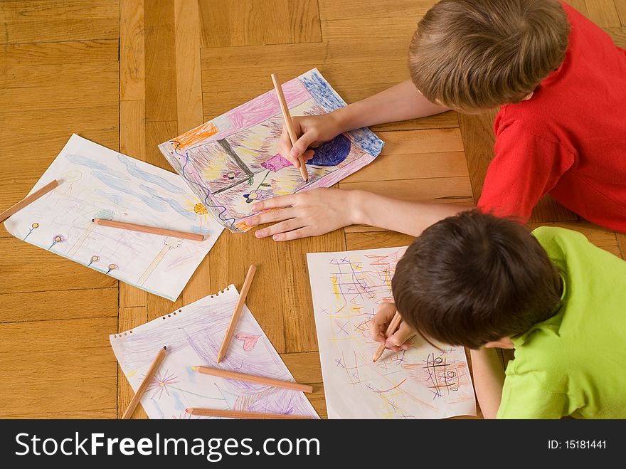 Brothers lying on the floor and draw. Brothers lying on the floor and draw