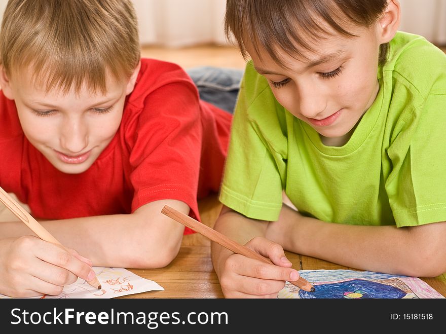 two brothers drawing on the floor