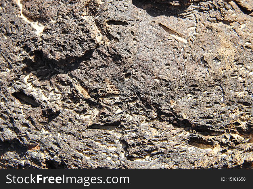 The black volcanic stone background texture. The black volcanic stone background texture.