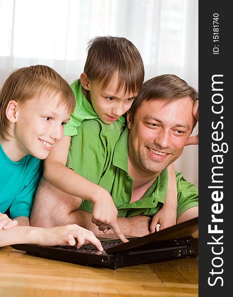 Father with his sons is with laptop