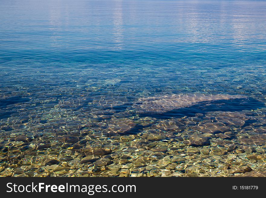 Clear blue water in a small bay in summer. Clear blue water in a small bay in summer.