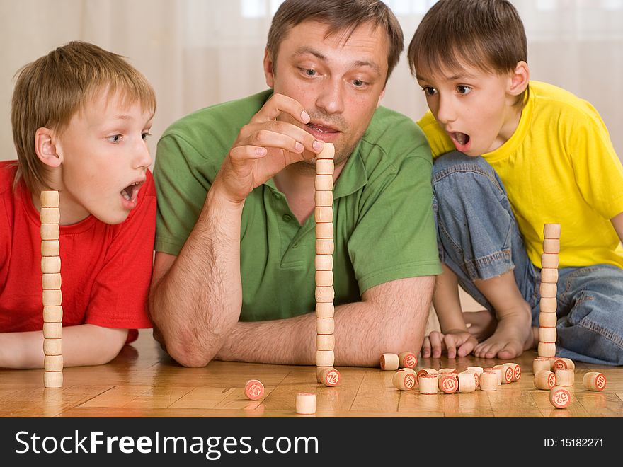 Happy father with children playing on the floor