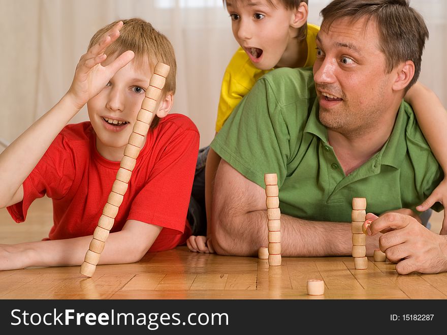 Happy father with children playing on the floor