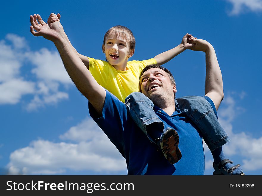 Happy father with his son on a background of sky