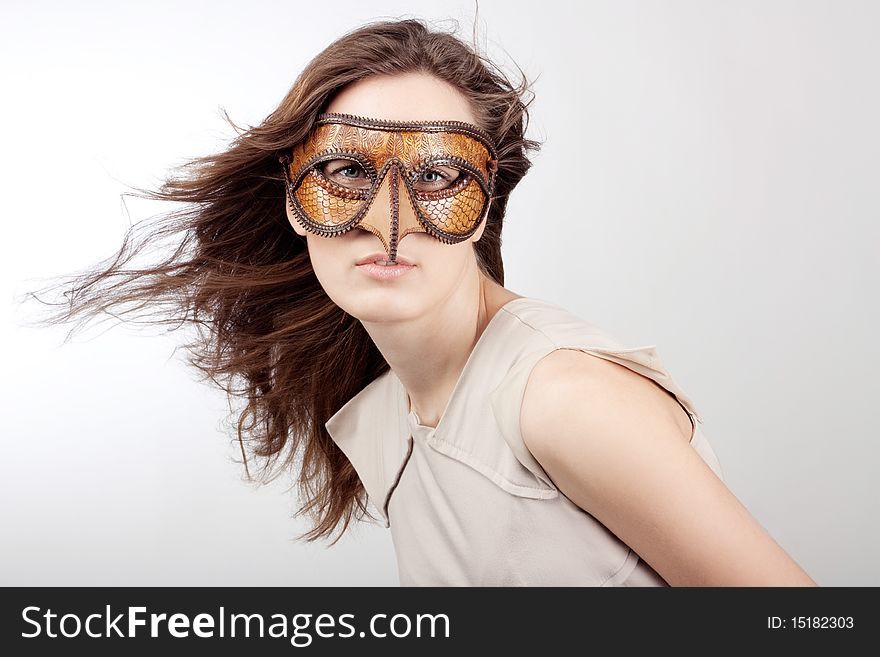 Young beautiful girl with the Venetian mask