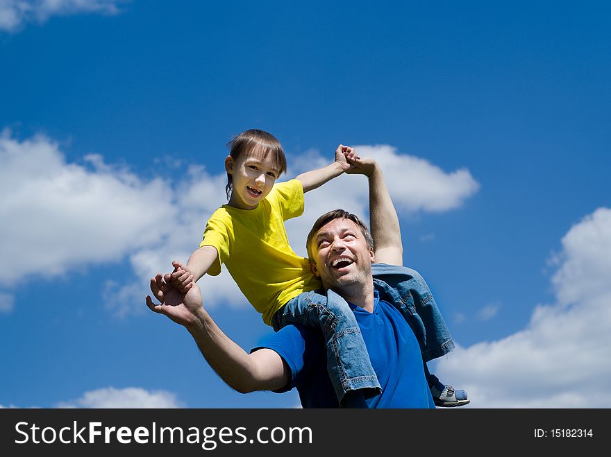 Happy father with his son on a background of sky