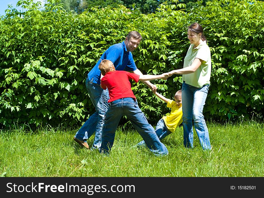 Happy boys with family in the summer park