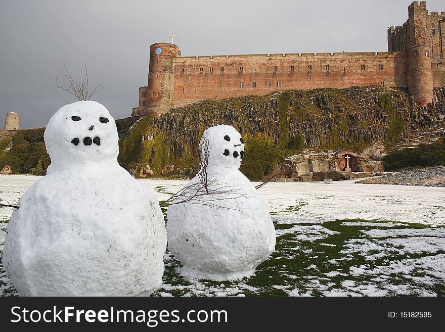 Snowmen in front of Bamburgh Castle, Northumberland
