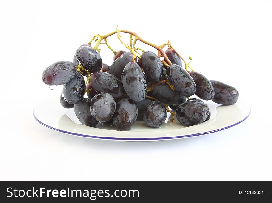Healthy blue grapes on plate isolated on white backgrounf