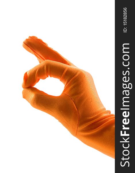 Hand in orange glove is making the ok sign over white
