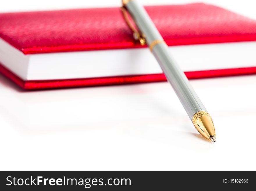 Red notebook with silver pen