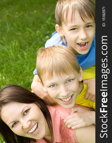 Happy boys with mom in the summer park