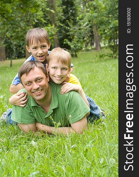 Father plays with young children outdoors. Father plays with young children outdoors