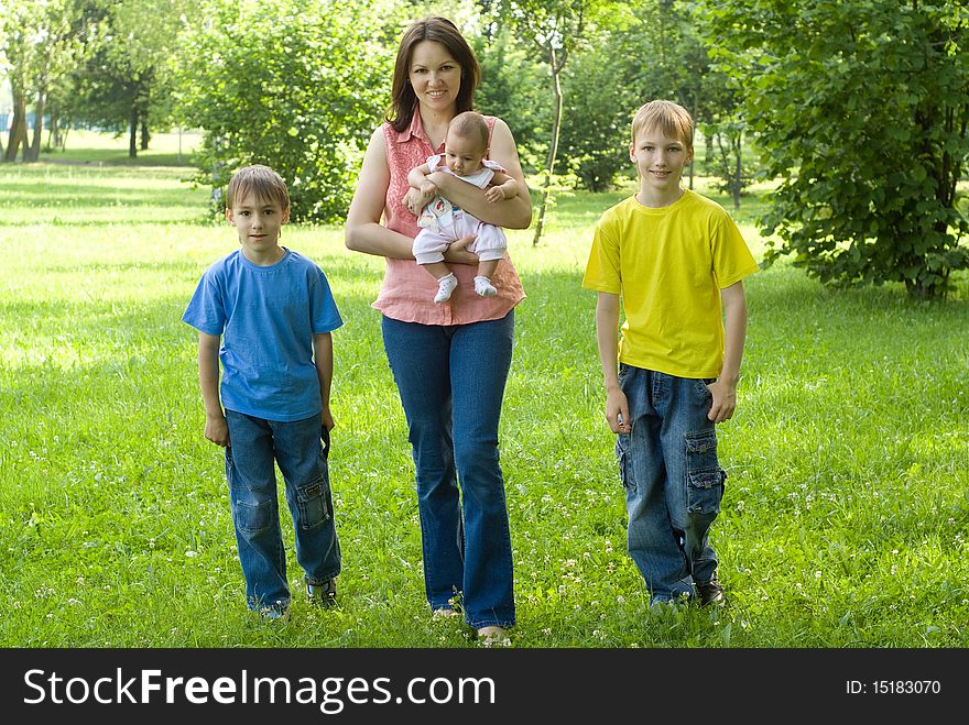Portrait of a happy family of four on the nature