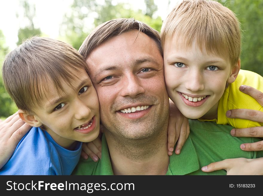 Dad plays with young children outdoors