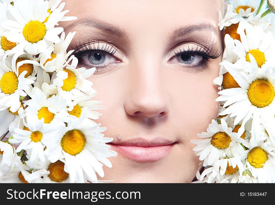 Beautiful woman with camomile.
