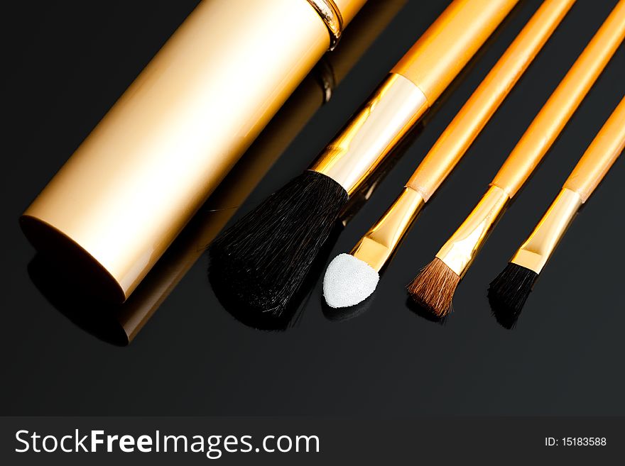 Cosmetic brushes on black background