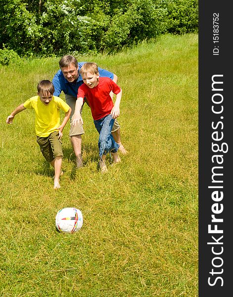 Dad playing with his children in football