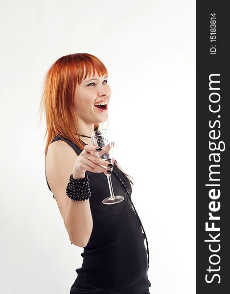 Beautiful red-haired girl lifts a toast, a glass with champagne