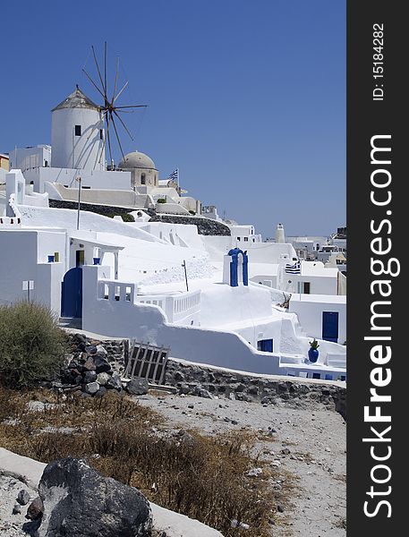 Windmill and white houses in Santorini Island. Windmill and white houses in Santorini Island