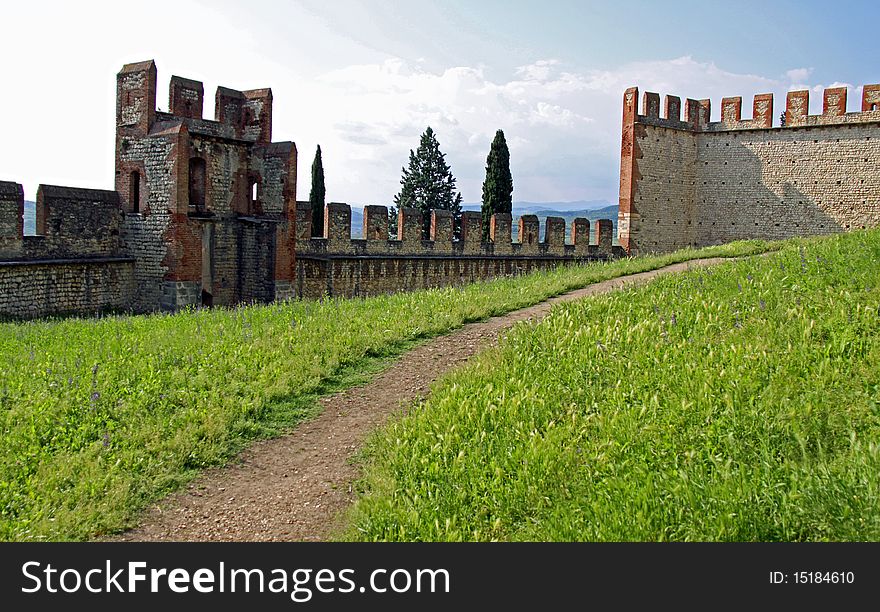 The fortified buildings and battlements of an Italian castle. The fortified buildings and battlements of an Italian castle