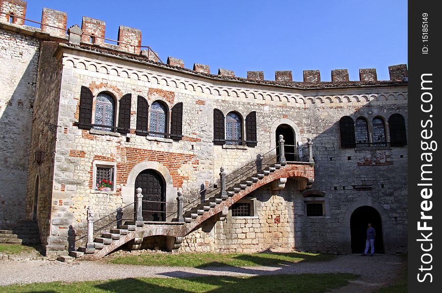 The fortified buildings and battlements of an Italian castle. The fortified buildings and battlements of an Italian castle