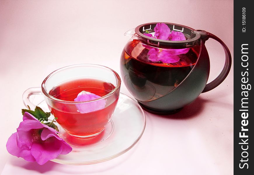 Herbal floral tea with wild rose on pink background