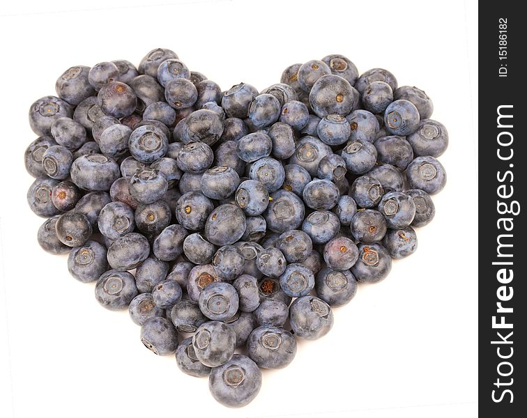 Blueberries in a heart shape on white background. Blueberries in a heart shape on white background