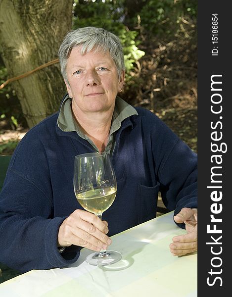 Senior women with wine glass in garden