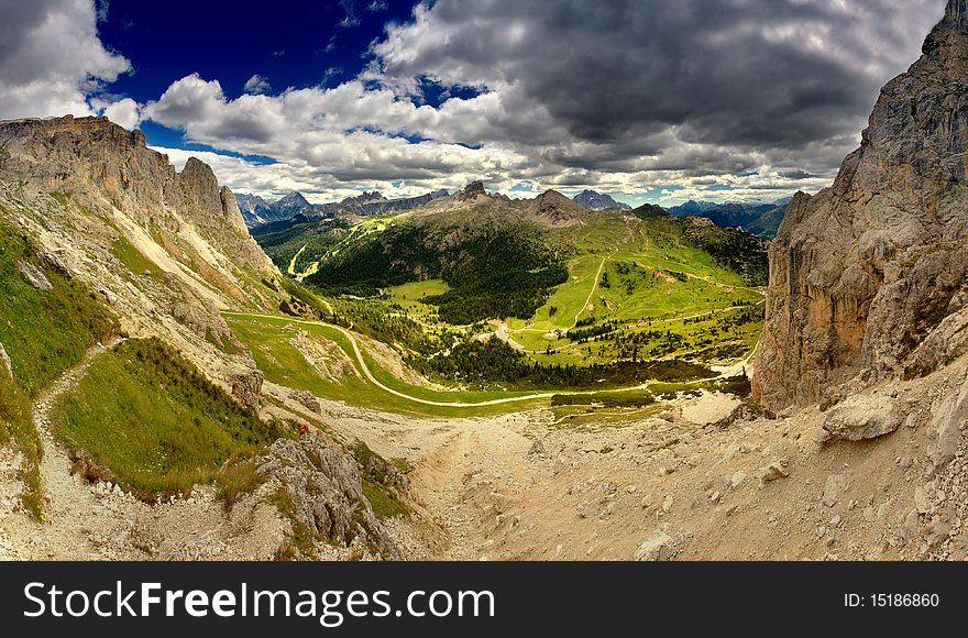 Stitched Panorama, Scenic view of Dolomite mountains pictured under stormy sky, Italy. Stitched Panorama, Scenic view of Dolomite mountains pictured under stormy sky, Italy.