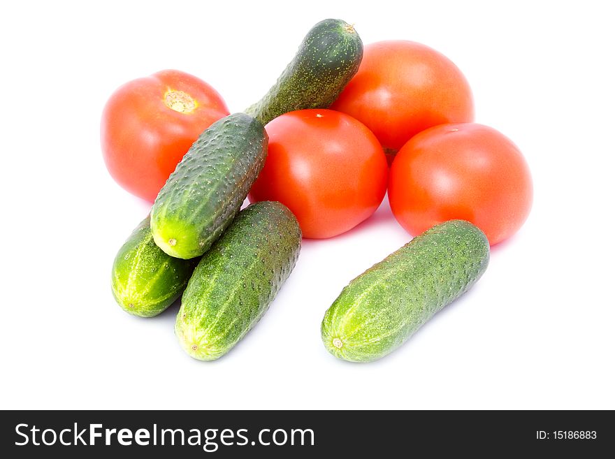 Cucumbers and tomatoes isolated on white background