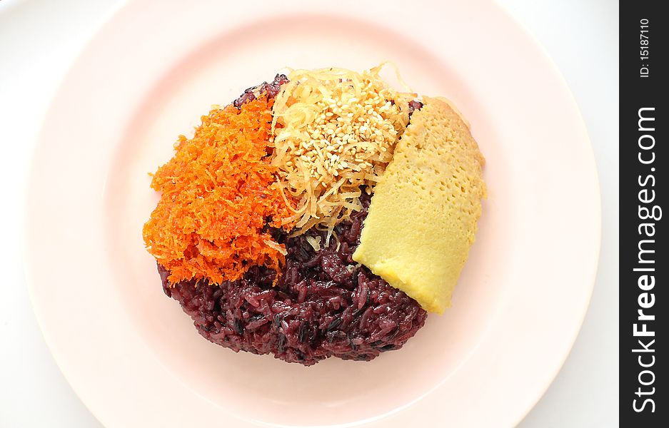 Thai style sweet desserts. Three type on glutinous rice, Sang ka ya (made from eggs and coconut milk), shred coconut and sesame, shrimp (orange color).