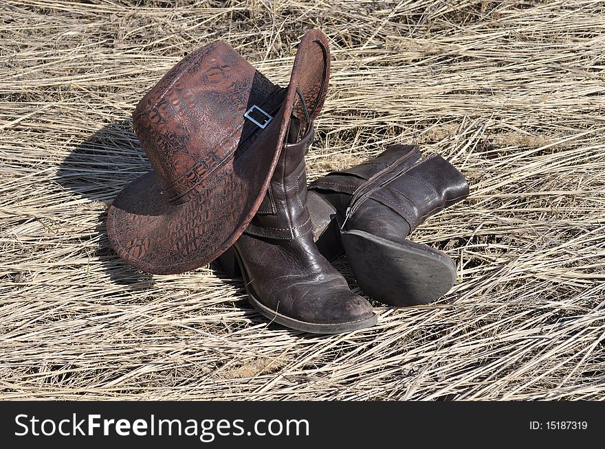 Stetson, lying on the straw hat and boots. Stetson, lying on the straw hat and boots