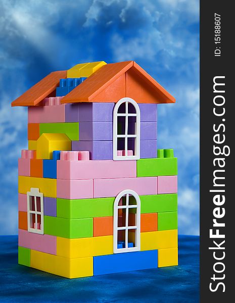 Toy house model on a blue sky background