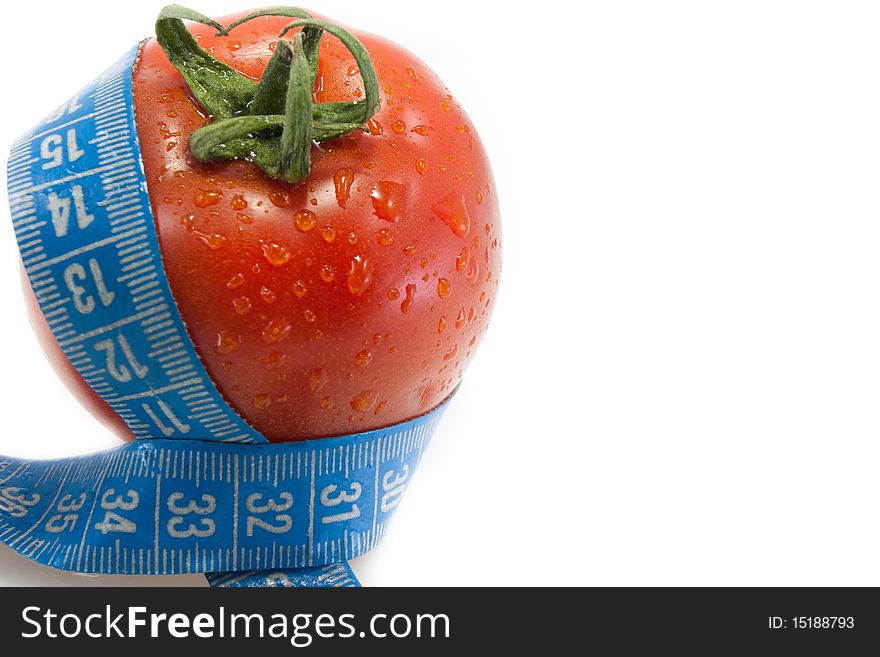 Juicy red tomato with blue measurement tape isolated on white, left side of the photo, right site is for text. Juicy red tomato with blue measurement tape isolated on white, left side of the photo, right site is for text