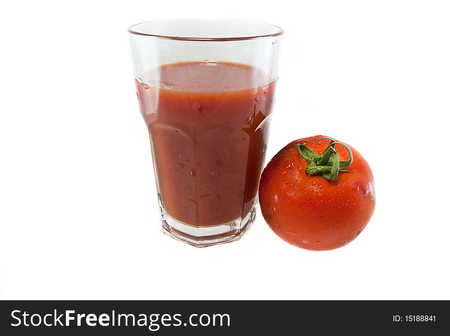 Big glass of tomato juice and a tomato isolated on white, for a healthy food. Big glass of tomato juice and a tomato isolated on white, for a healthy food