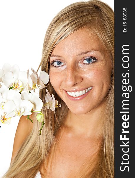 Young blond tan caucasian woman with orchid flowers isolated