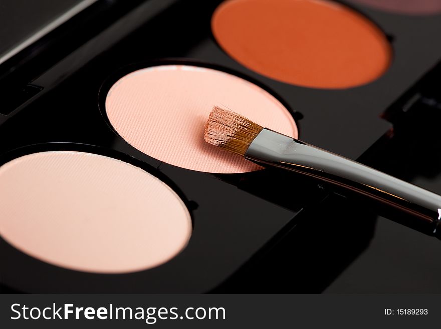 Make-up eyeshadows and cosmetic brush