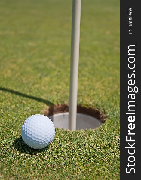 Golf hole with ball and flag