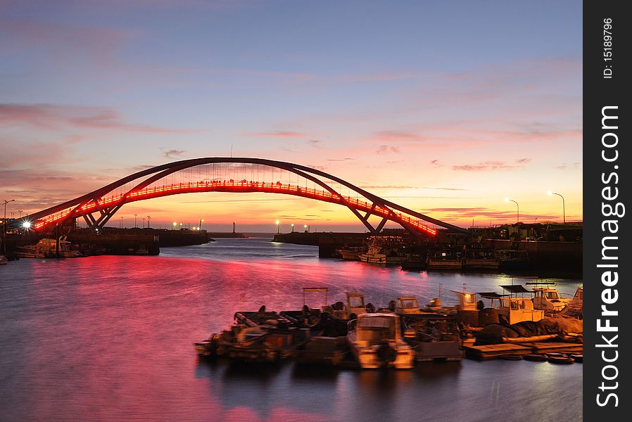 A beautiful sunset at the port with a bridge. A beautiful sunset at the port with a bridge