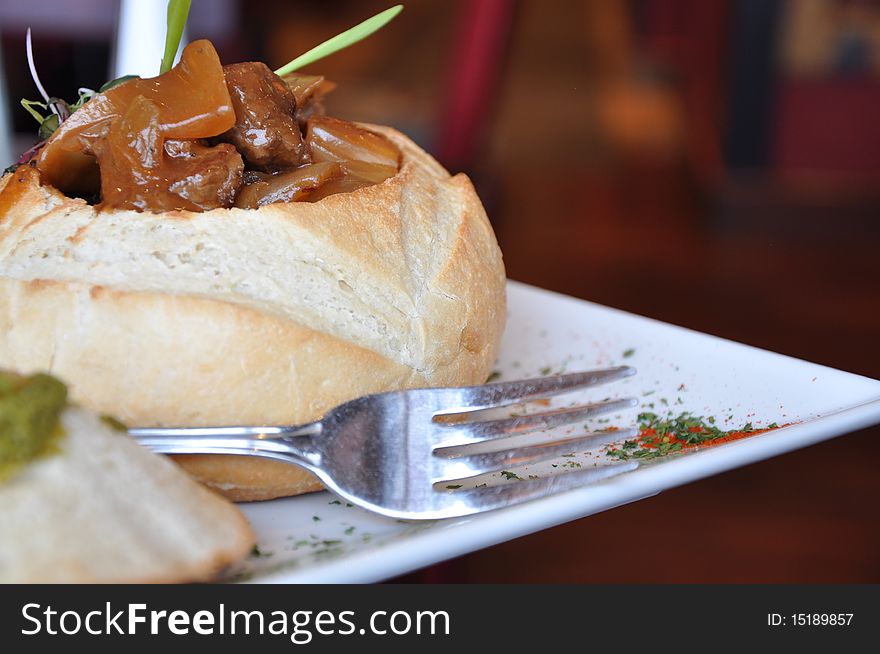 Hot and succulent beef stew served in a pastry breaded bowl. Hot and succulent beef stew served in a pastry breaded bowl.