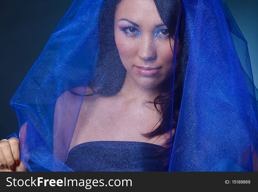 Beautiful girl with blue veil