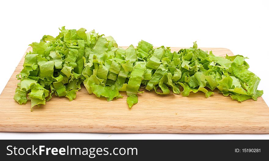 Green lettuce salad slices on wooden plate