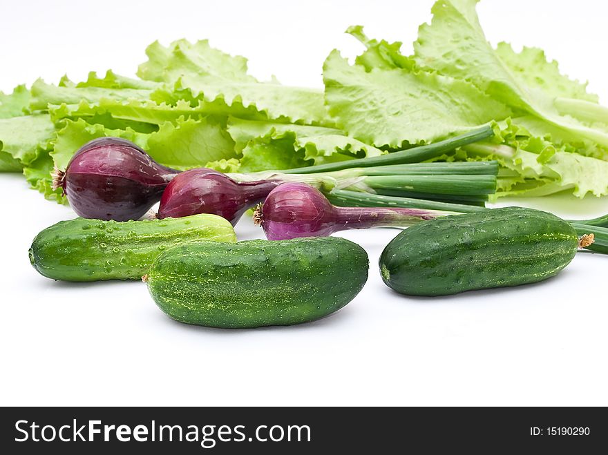 Green cucumbers with onion and lettuce salad