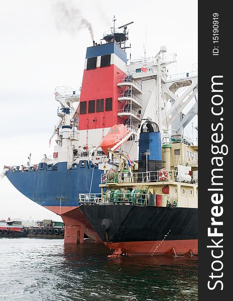 Two cargo ships of different size moored at port. Two cargo ships of different size moored at port.