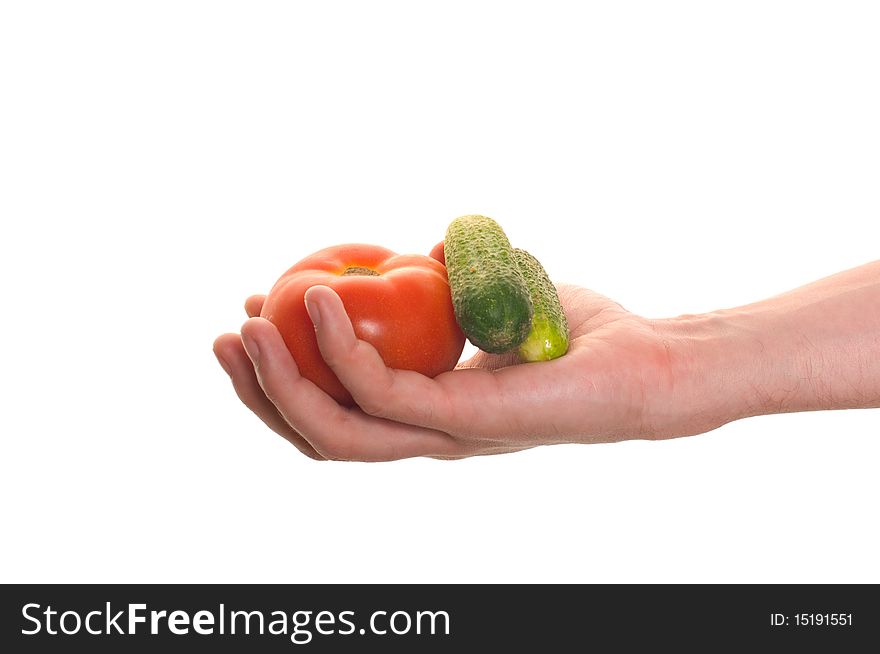 Well shaped hand with fresh vegetables isolated over white